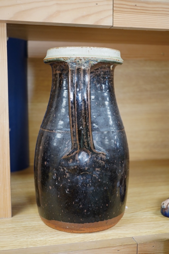 Richard Batterham (1936-2021), a tall Stoneware black glazed jug, with a cream rim, 28cm high. Condition - good